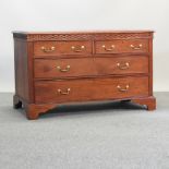 A 19th century style low chest of drawers, on bracket feet,