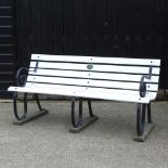 A cast iron and white painted slatted wooden garden bench,