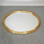 An oval gilt framed wall mirror,