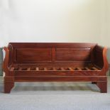 A hardwood day bed, with a slatted wooden base,