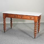 A Victorian satin walnut washstand, with a marble top, on spirally turned legs,