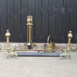 A pair of American brass fire dogs, 52cm high, together with a companion set,