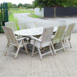 A teak extending garden table, bearing a label for Lindsay 240 x 120cm overall,