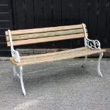 An oak slatted garden bench, with white painted metal ends,