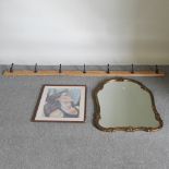 A gilt framed shaped wall mirror, 101 x 63cm, together with a portrait,