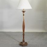 A continental carved and gilt wooden standard lamp and shade,