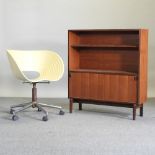 A 1970's moulded plastic swivel desk chair, on a chrome base, together with a 1960's side cabinet,