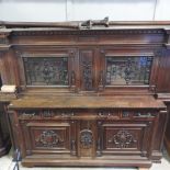 An early 20th century continental carved mahogany buffet, with a glazed upper section,