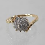 A 14 carat gold diamond cluster ring, of asymmetric design,
