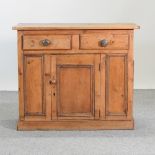 An antique pine cabinet,