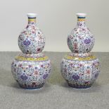 A pair of Chinese porcelain polychrome painted vases, of gourd shape,