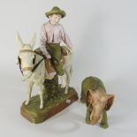 A Royal Dux figure of a boy riding a donkey,