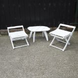 A pair of white painted wooden garden chairs, together with a similar coffee table,