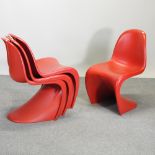 A set of four contemporary red moulded chairs,