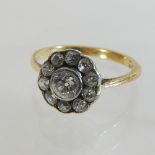 A 18 carat gold and diamond daisy ring,