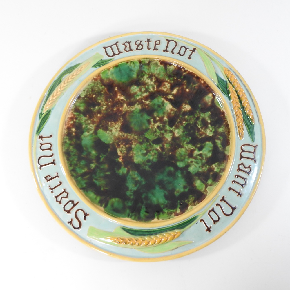 A 19th century Minton style majolica plate, inscribed 'Spare not, waste not, want not',