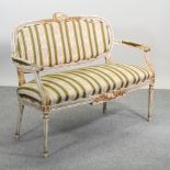A French style cream painted show frame sofa, with green striped upholstery,