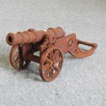 A small rusted model of a cannon,