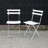 A set of six white painted metal folding garden chairs