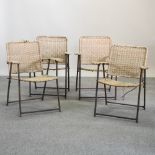 A set of four metal framed woven chairs