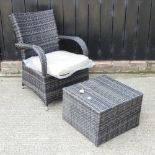 A rattan garden armchair, with cushion, together with a coffee table,