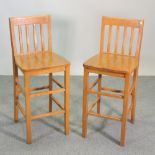 A pair of modern beech bar stools