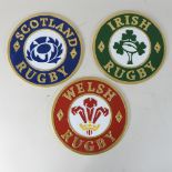 A set of three painted cast iron Welsh, Irish and Scotland rugby circular wall signs,
