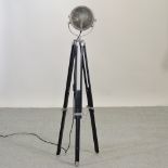 A reproduction chrome stage light standard lamp, on a tripod base,