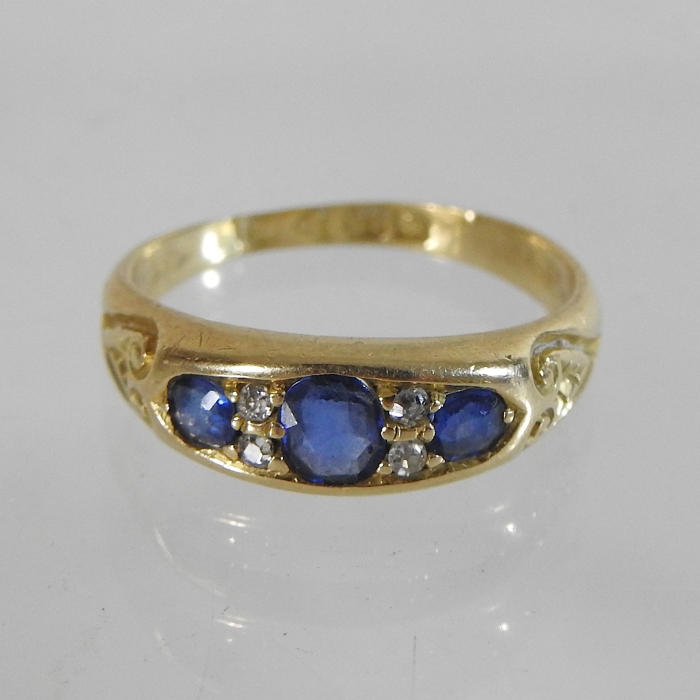 An 18 carat gold, sapphire and diamond five stone ring,