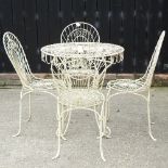 A white painted wire framed garden table, 74cm diameter, together with four matching chairs,