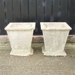 A pair of reconstituted stone planters,