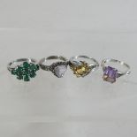 A collection of four silver rings,