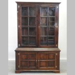 A 19th century style oak cabinet bookcase,
