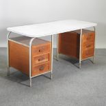 A 1930's wooden, melamine and tubular metal desk,