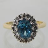 A 14 carat gold blue topaz and diamond cluster ring,