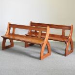 A pair of early 20th century pine church pews,