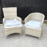 A beige rattan garden armchair,