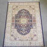 A Keshan style carpet, with a central medallion, on a green ground,