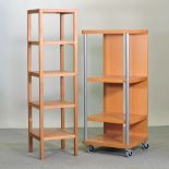 A modern wooden five tier stand, together with another, on castors,