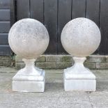 A pair of reconstituted stone ball garden markers,