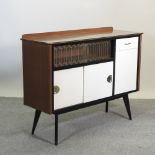 A vintage sideboard, with white sliding doors,