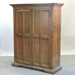 A 19th century continental walnut side cabinet, fitted with shelves, enclosed by panelled doors,