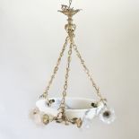 An early 20th century French gilt metal and alabaster ceiling light, with six foliate supports,