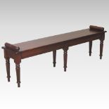 A Regency style mahogany window seat, on six turned legs,