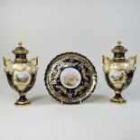 A pair of early 20th century Coalport porcelain vases and covers, each of urn shape,