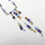 A 14 carat white gold and coloured stone necklace, set with peridots,
