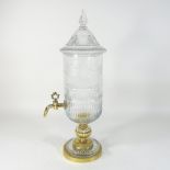 A cut glass and brass mounted urn,