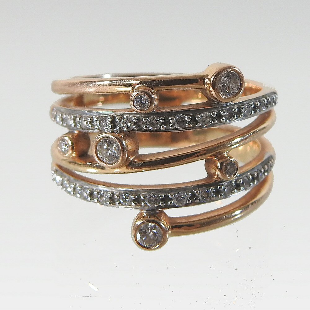 A modern rose gold and white gold diamond ring, of asymmetrical design,