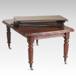 A Victorian mahogany extending dining table, with three additional leaves, on reeded legs,