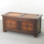 An 18th century style carved coffer, with carved panels,